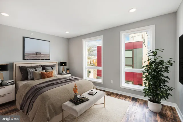 a bedroom with a bed and a potted plant