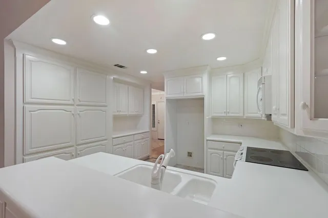 an empty room with a fireplace and a window