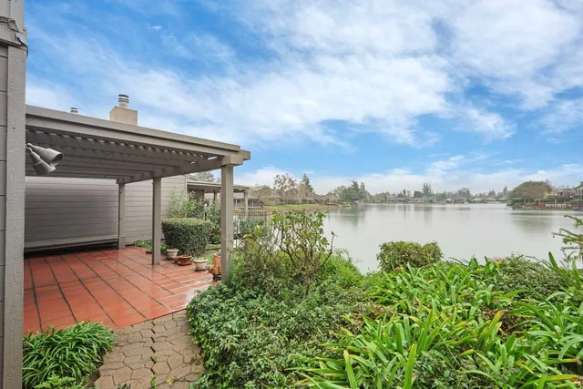 a view of a house with a yard and a lake view