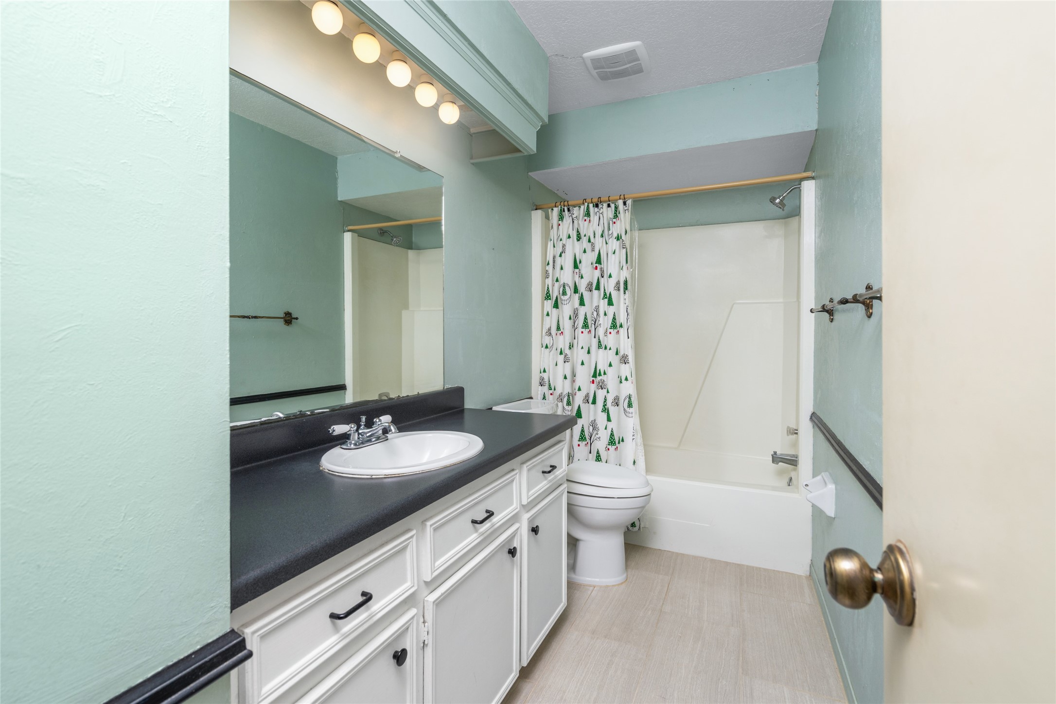 7015 Rosebrook Circle Spring, TX 77379 - Photo 11 of 15 Full guest bathroom is equipped with long vanity counter space, custom trim, and a clean tub-shower combo.
