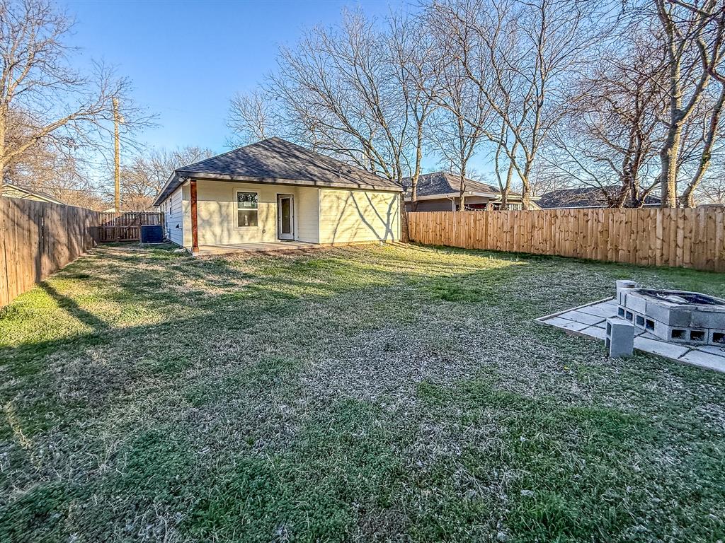 815 Ritchey Street Gainesville, TX 76240 - Photo 18 of 18 a view of a house with a yard