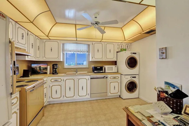 a kitchen with stainless steel appliances granite countertop a sink a stove and cabinets