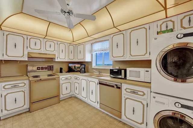 a kitchen with stainless steel appliances granite countertop cabinets and a stove top oven