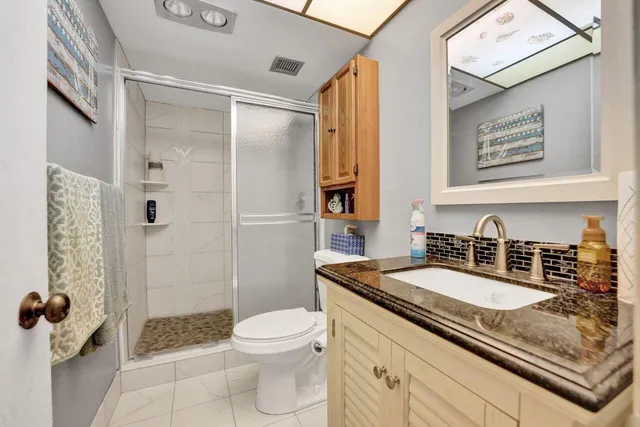 a bathroom with a sink toilet and shower