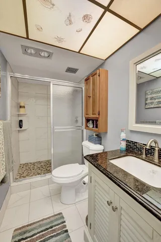 a bathroom with a sink mirror and vanity