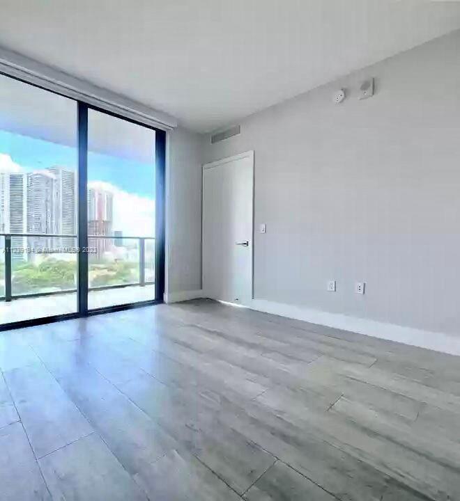 Midtown Miami Miami, FL 33137 - Photo 11 of 23 a view of an empty room with wooden floor and a window
