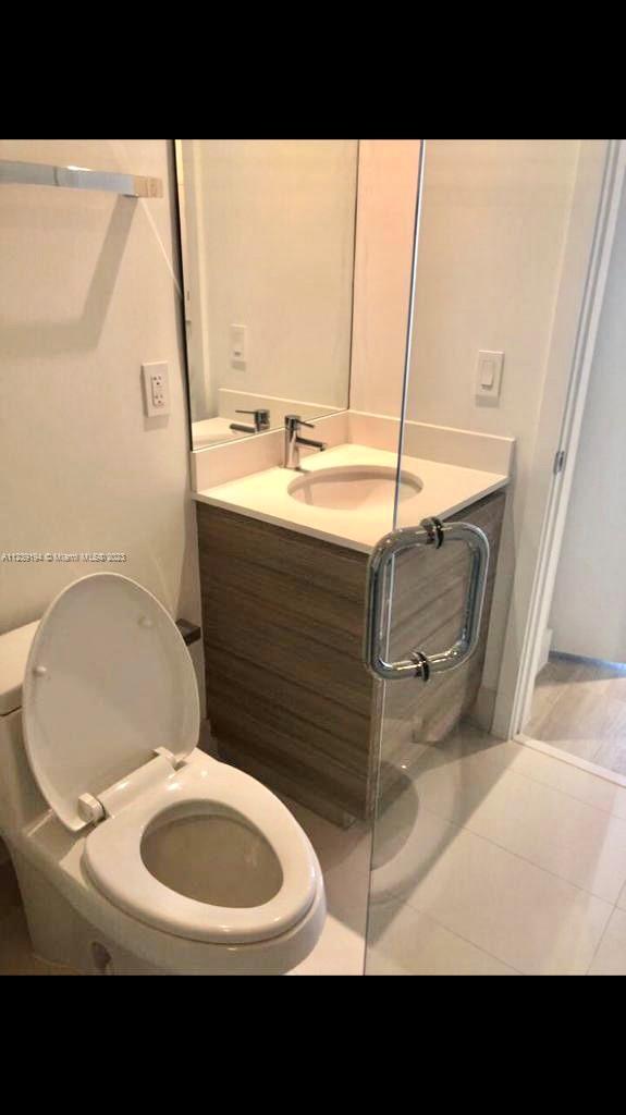 Midtown Miami Miami, FL 33137 - Photo 12 of 23 a bathroom with a sink mirror vanity and toilet