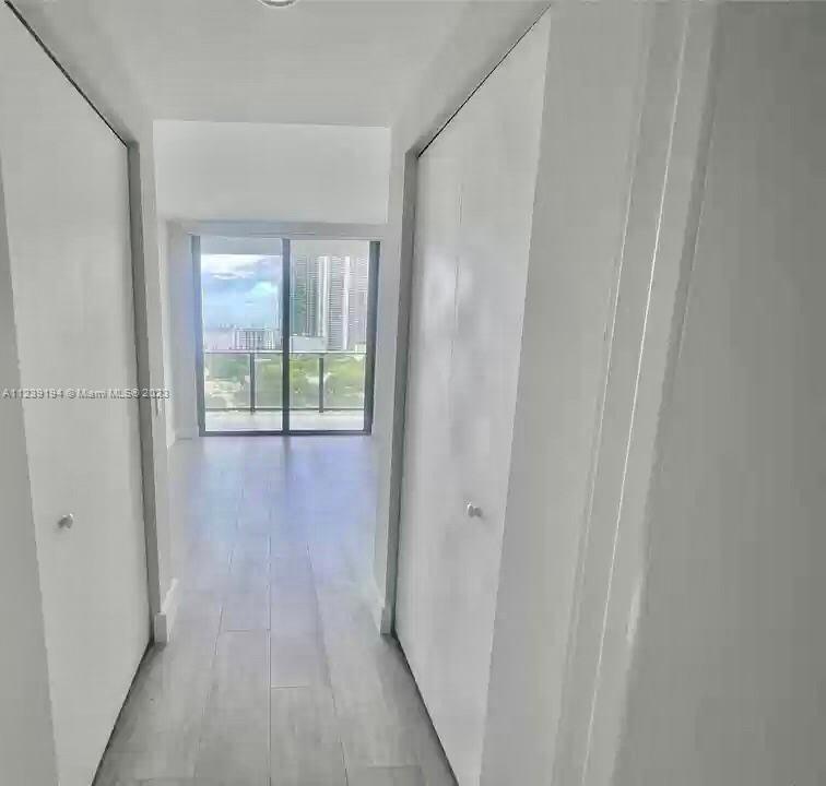 Midtown Miami Miami, FL 33137 - Photo 8 of 23 a view of a hallway with wooden floor