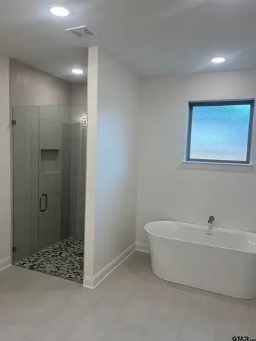 a bathroom with a bathtub and shower