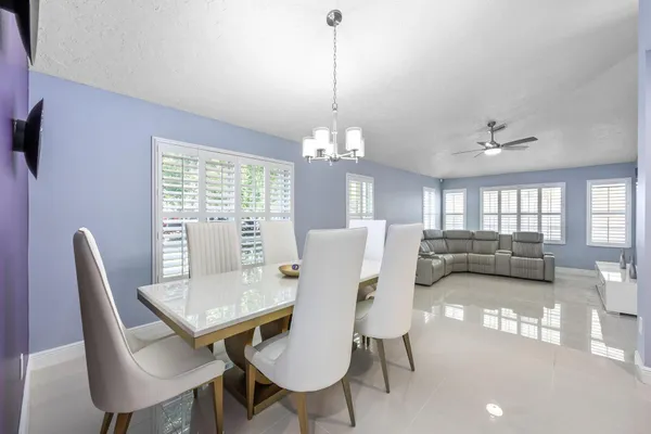 a bathroom with a sink a toilet a large mirror and shower