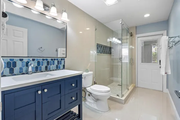 a bedroom with a bed and a night stand