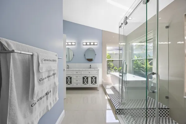 a kitchen with stainless steel appliances granite countertop white cabinets a stove and a sink