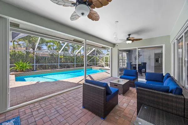 a view of a backyard with a fountain plants and large tree