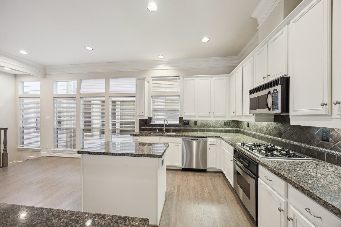 633 Hartman Street Houston, TX 77007 - Photo 7 of 23 a kitchen with stainless steel appliances granite countertop a stove a sink and a microwave