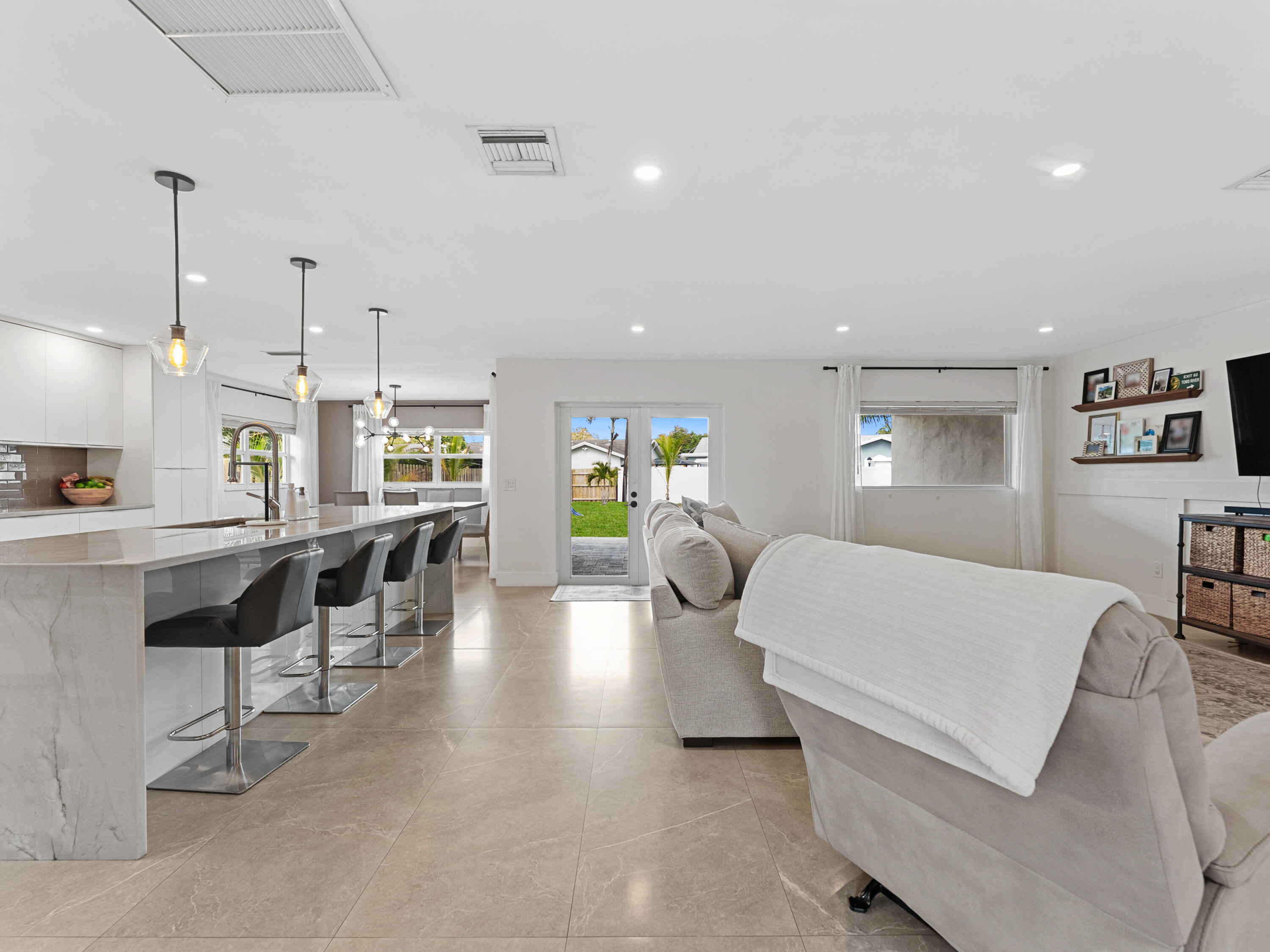9329 Southwest 2nd Street Boca Raton, FL 33428 - Photo 11 of 42 a living room with furniture and a table