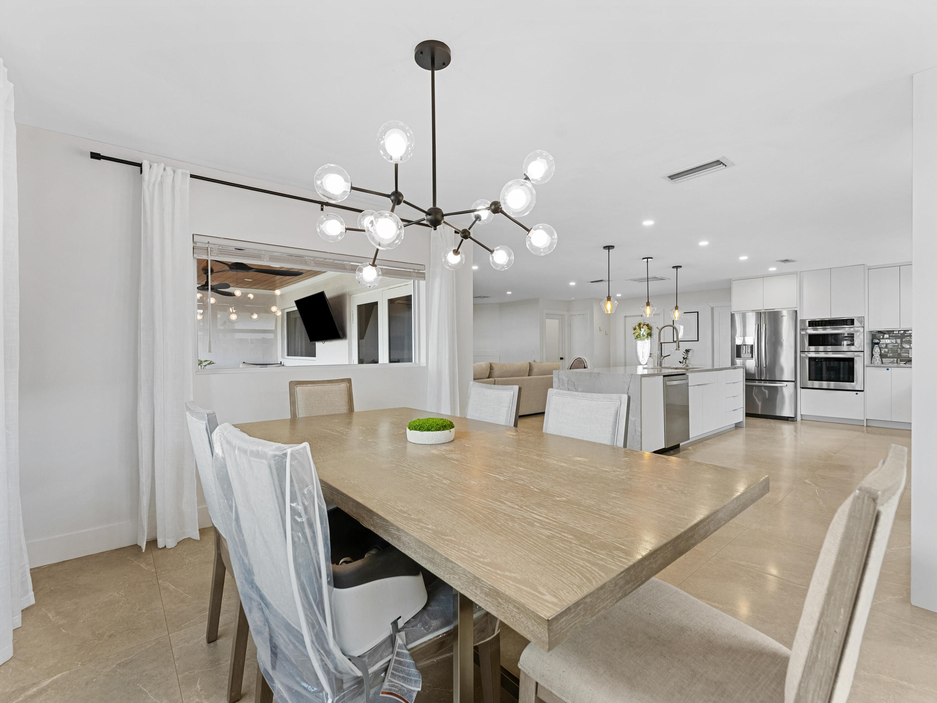 9329 Southwest 2nd Street Boca Raton, FL 33428 - Photo 12 of 42 a dining room with furniture and window