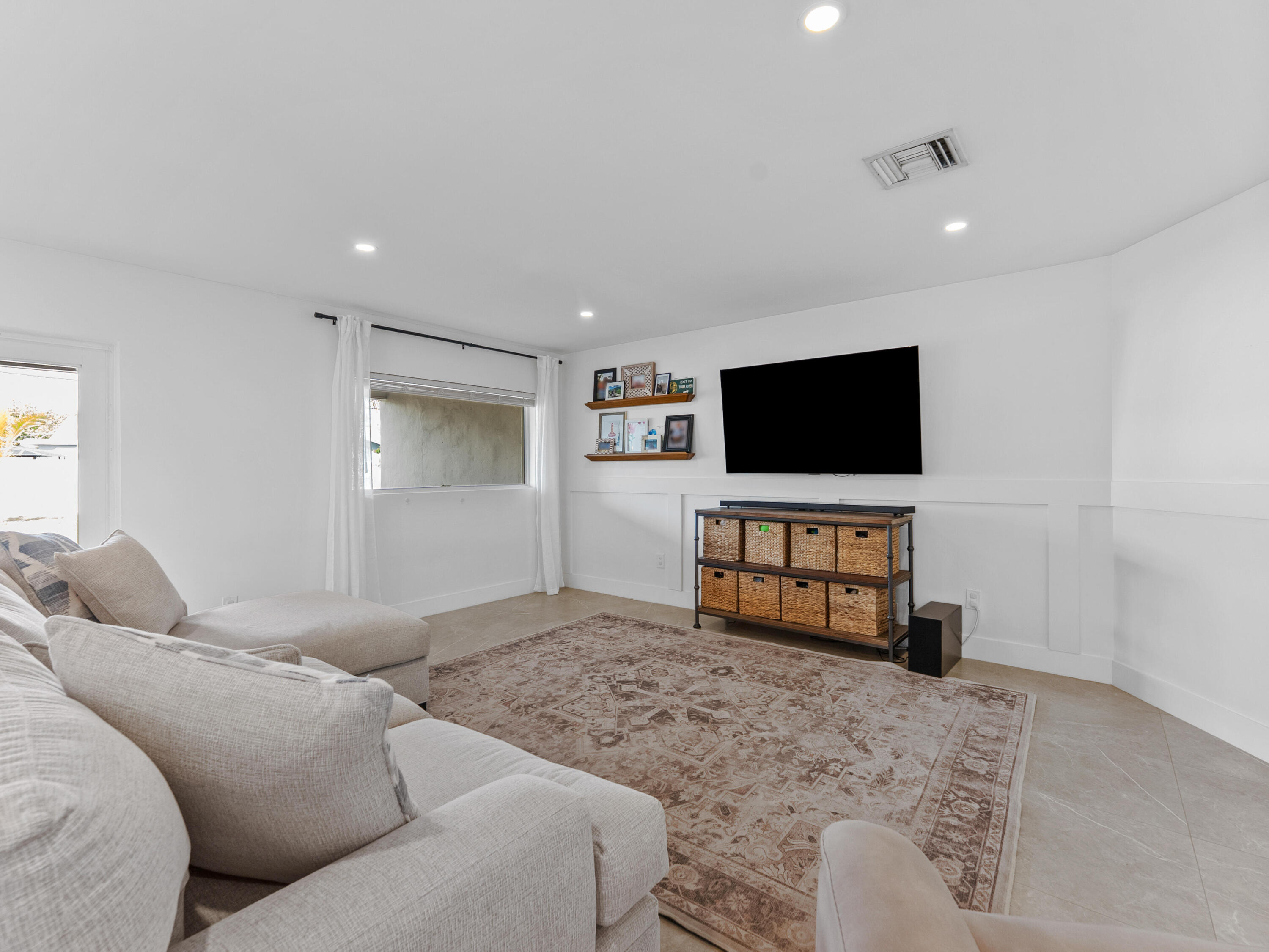 9329 Southwest 2nd Street Boca Raton, FL 33428 - Photo 15 of 42 a living room with furniture and a flat screen tv