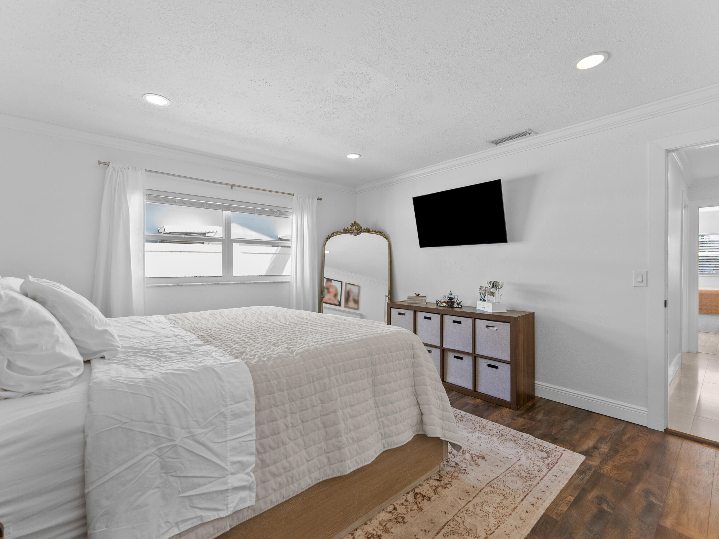 9329 Southwest 2nd Street Boca Raton, FL 33428 - Photo 22 of 42 a bedroom with a bed and a flat screen tv