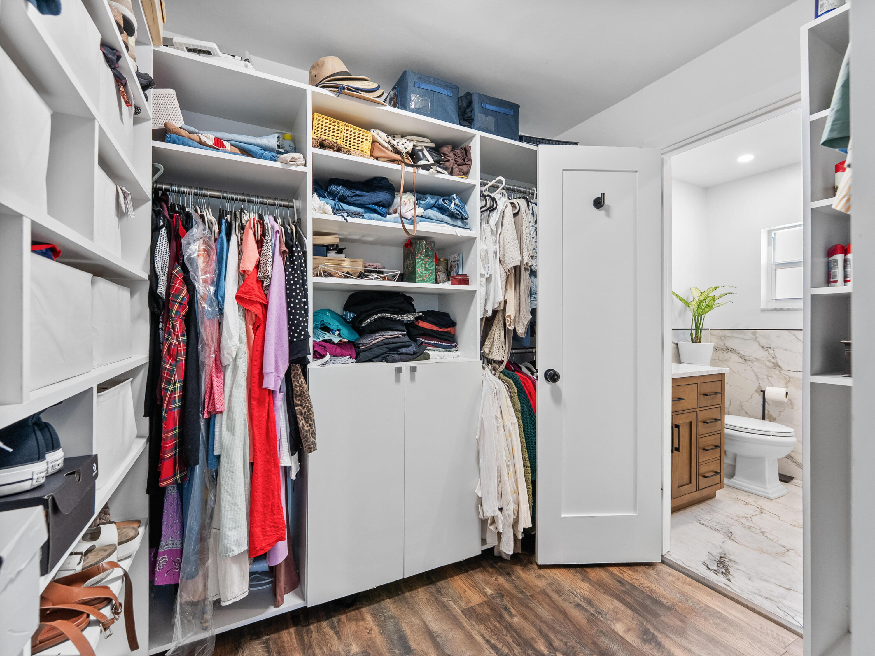 9329 Southwest 2nd Street Boca Raton, FL 33428 - Photo 23 of 42 a view of walk in closet with clothes and shoes