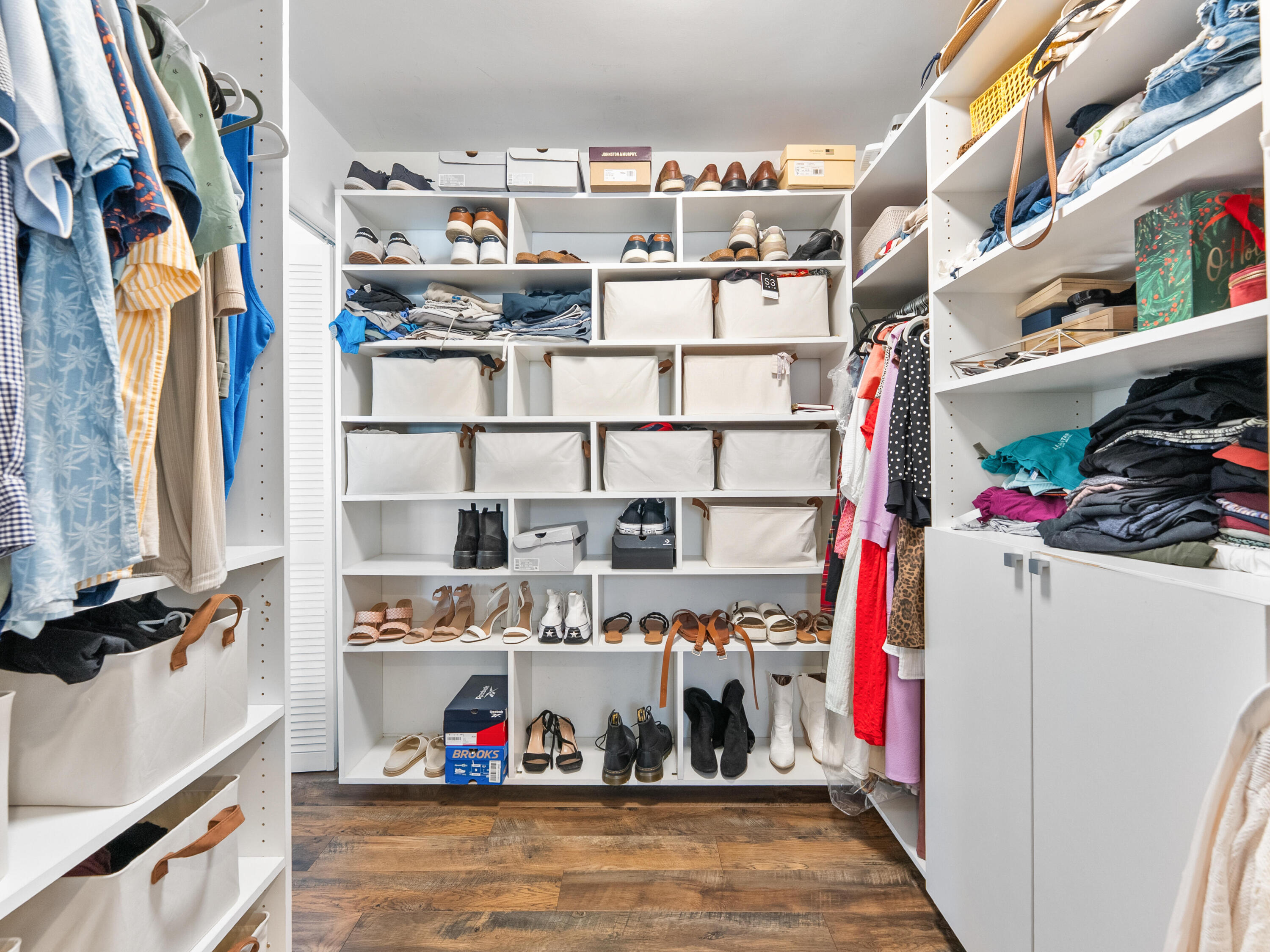 9329 Southwest 2nd Street Boca Raton, FL 33428 - Photo 24 of 42 a view of walk in closet with clothes and shoes