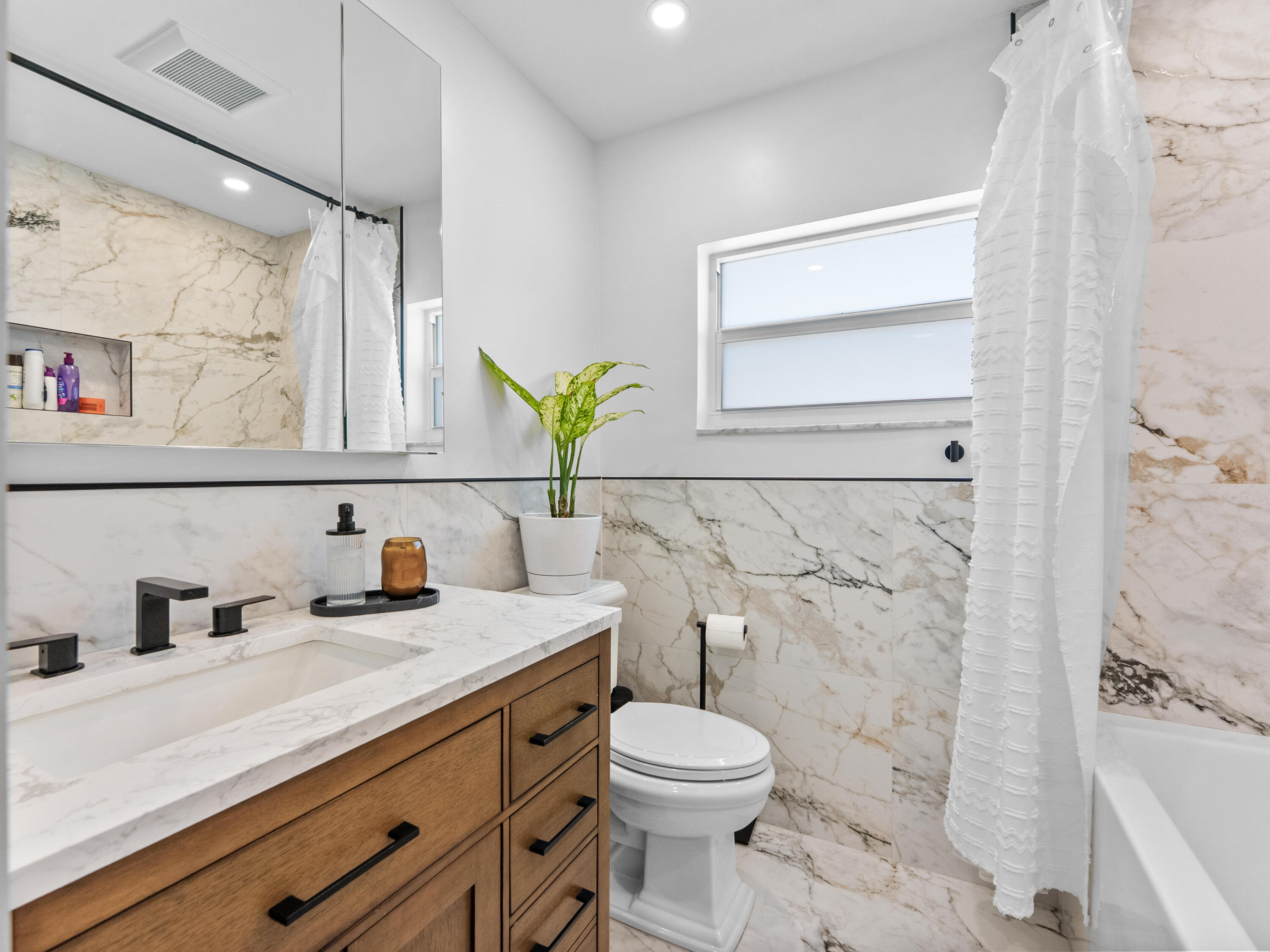 9329 Southwest 2nd Street Boca Raton, FL 33428 - Photo 26 of 42 a bathroom with a granite countertop sink mirror vanity and toilet