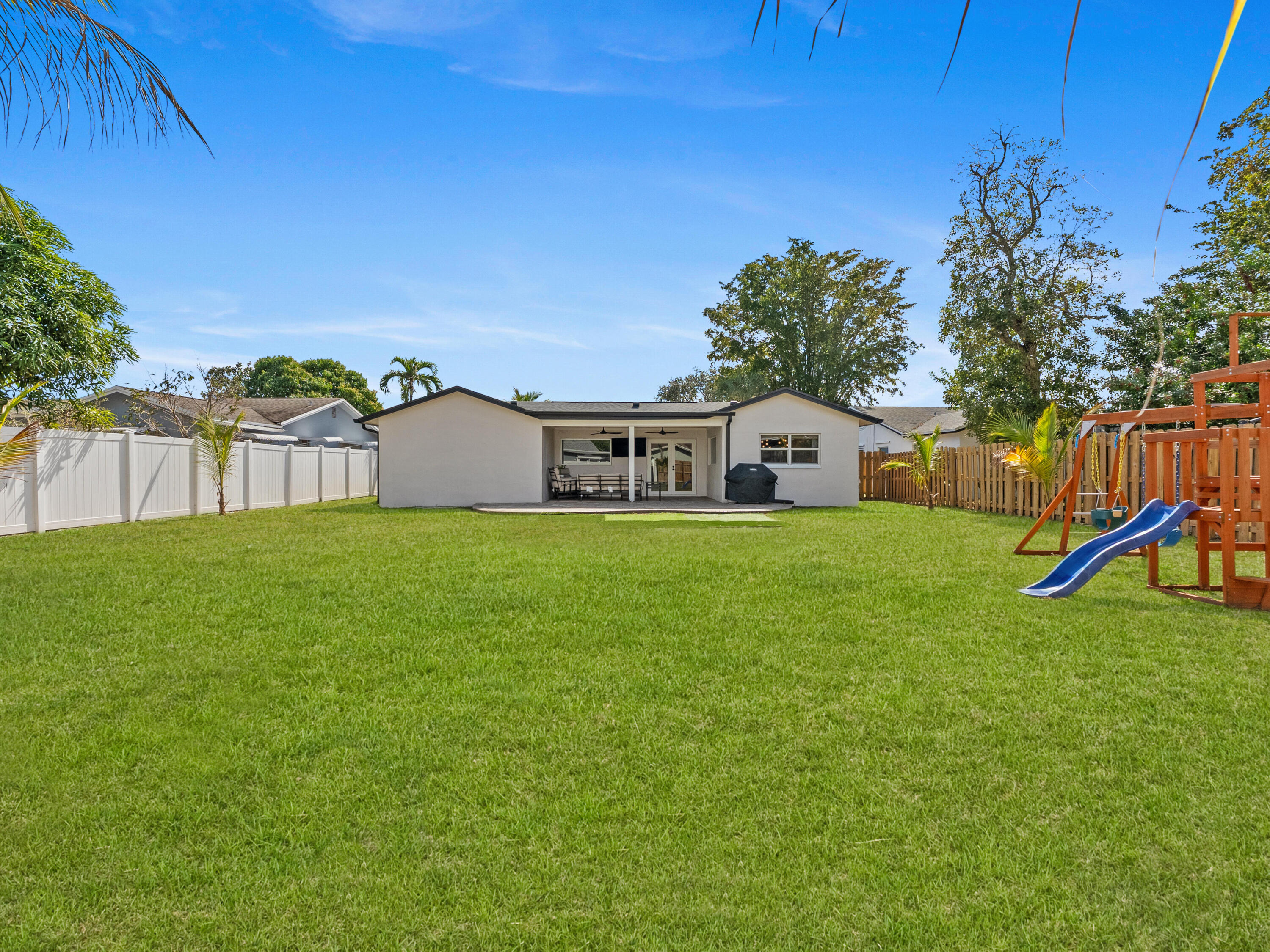 9329 Southwest 2nd Street Boca Raton, FL 33428 - Photo 32 of 42 a house view with a garden space