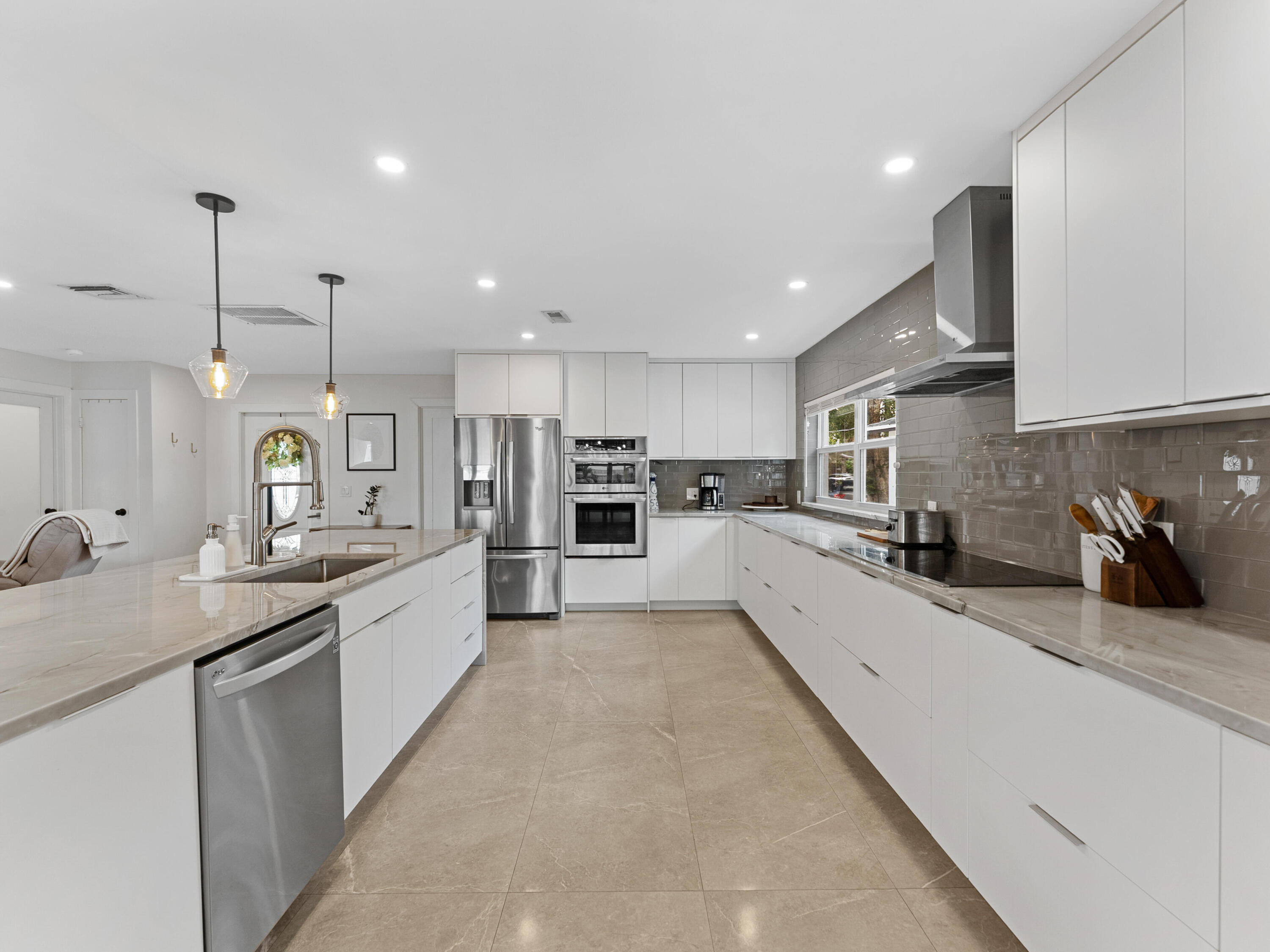 9329 Southwest 2nd Street Boca Raton, FL 33428 - Photo 8 of 42 a large kitchen with stainless steel appliances lots of counter space sink and cabinets