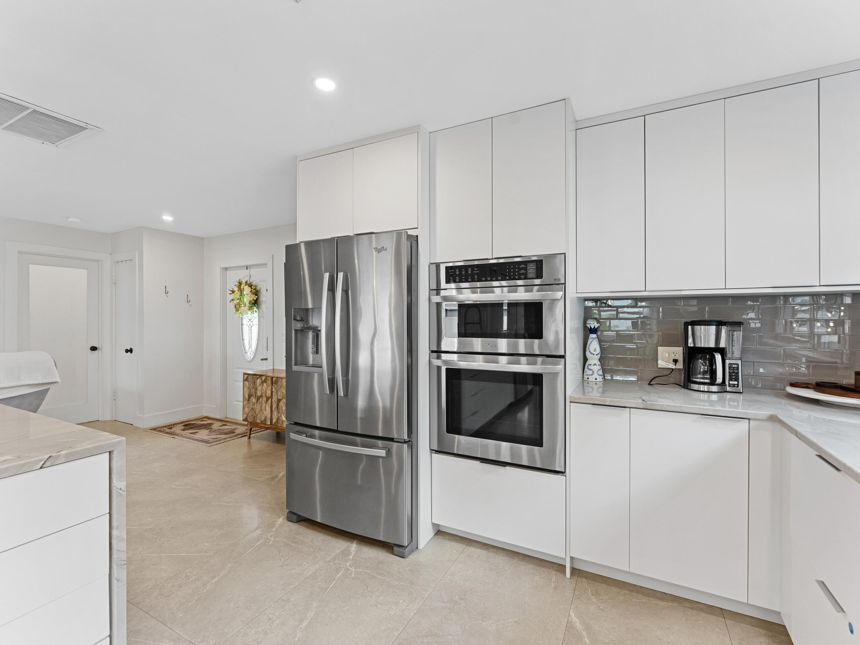9329 Southwest 2nd Street Boca Raton, FL 33428 - Photo 9 of 42 a kitchen with stainless steel appliances granite countertop a refrigerator and a stove top oven