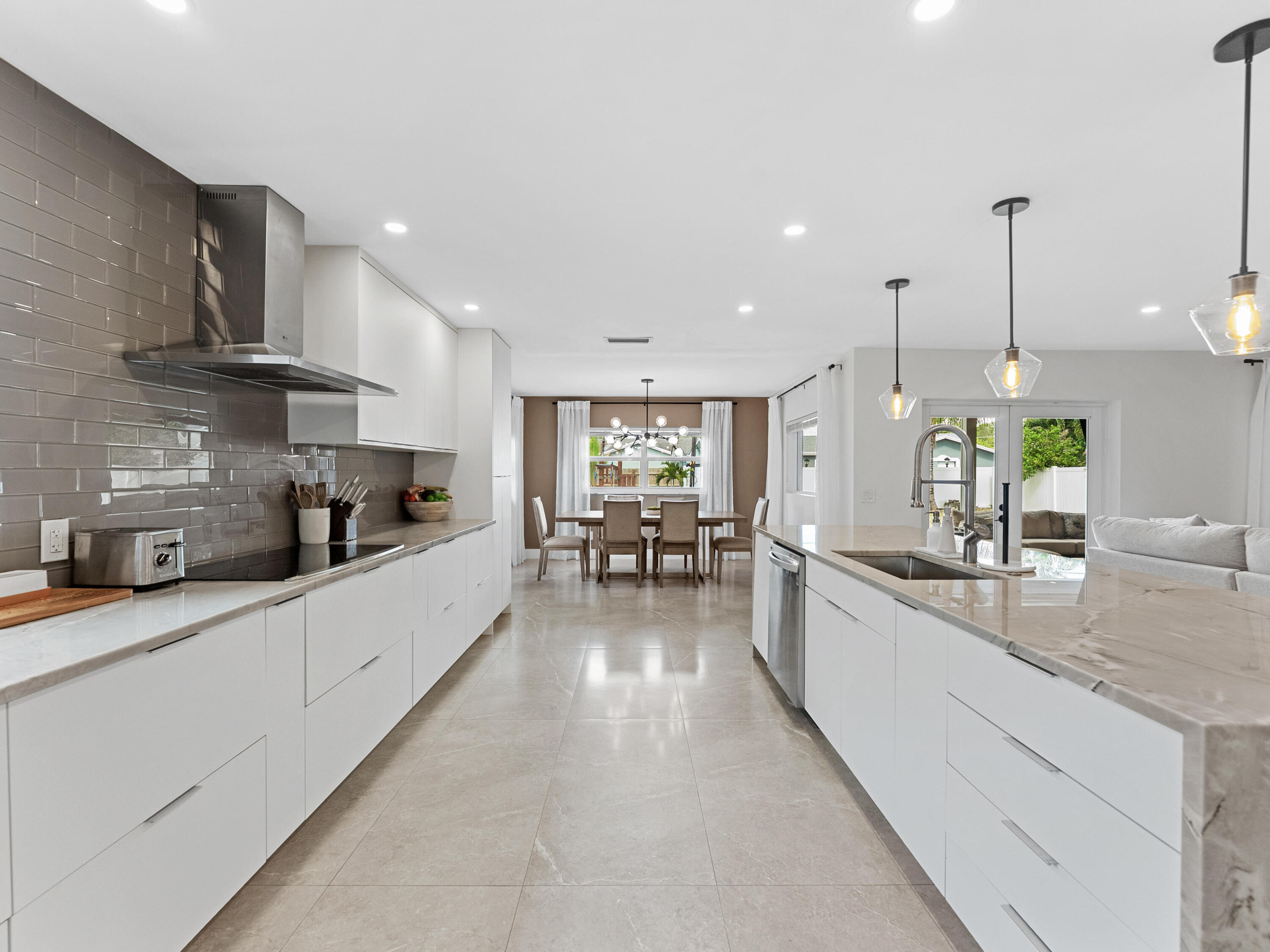 9329 Southwest 2nd Street Boca Raton, FL 33428 - Photo 10 of 42 a large kitchen with stainless steel appliances lots of counter space and a sink