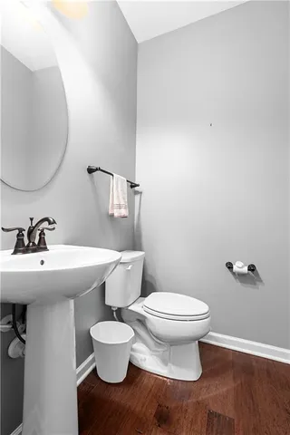 a white toilet sitting next to a bathroom sink