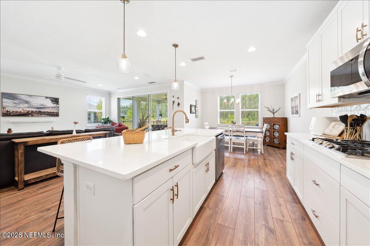 223 Tanner Trail St. Augustine, FL 32092 - Photo 17 of 44 a kitchen with stainless steel appliances kitchen island granite countertop a stove and a wooden floors