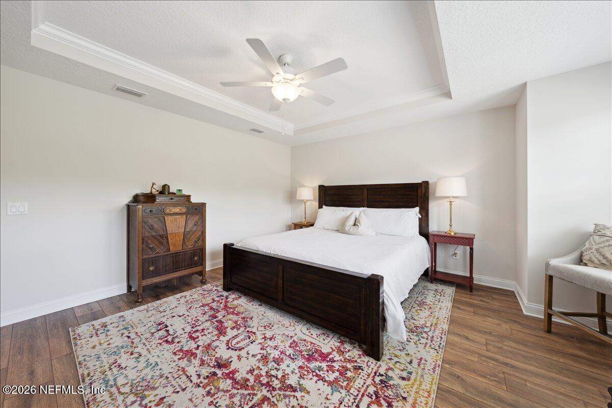 223 Tanner Trail St. Augustine, FL 32092 - Photo 23 of 44 a bedroom with a bed and a chandelier