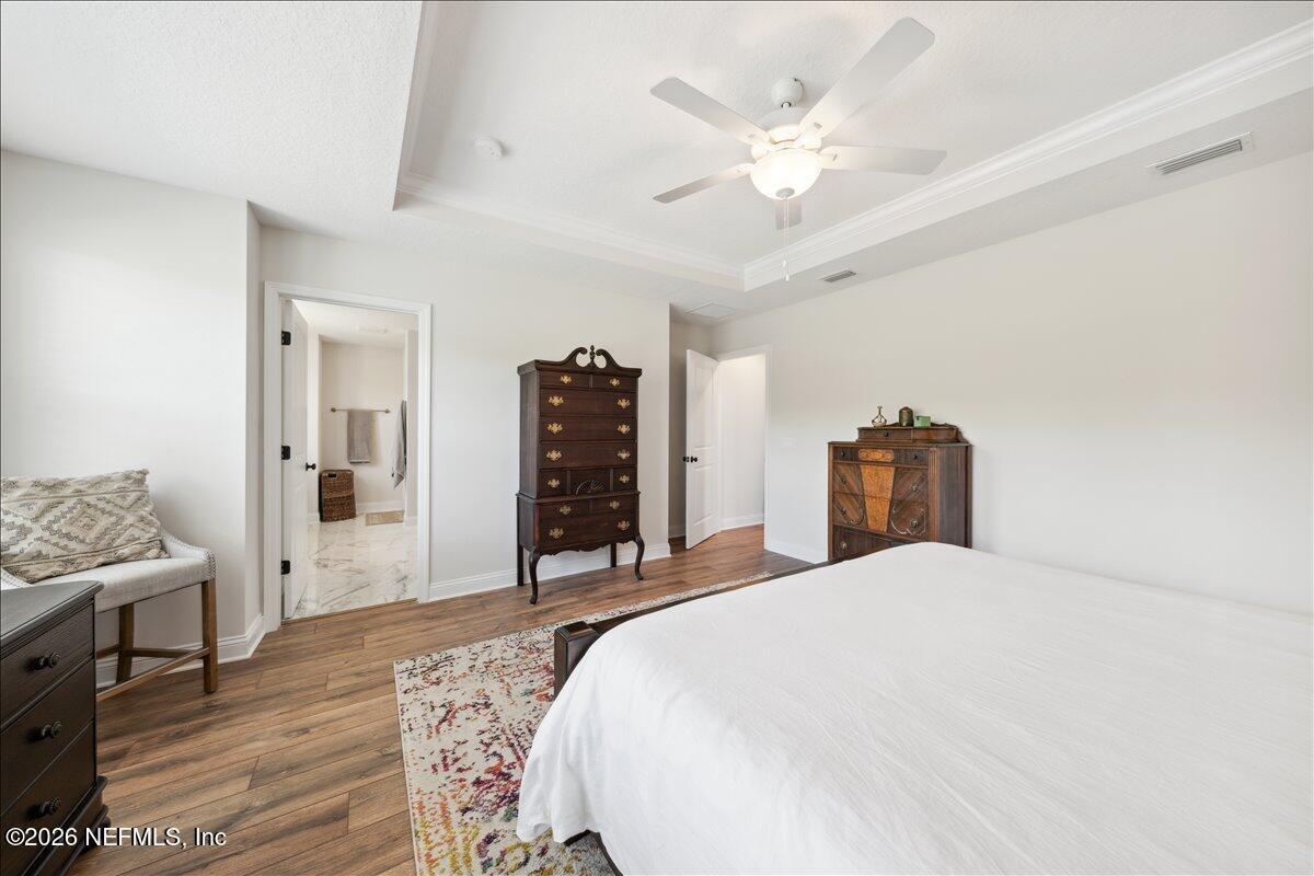 223 Tanner Trail St. Augustine, FL 32092 - Photo 24 of 44 a bedroom with a large bed and a chandelier