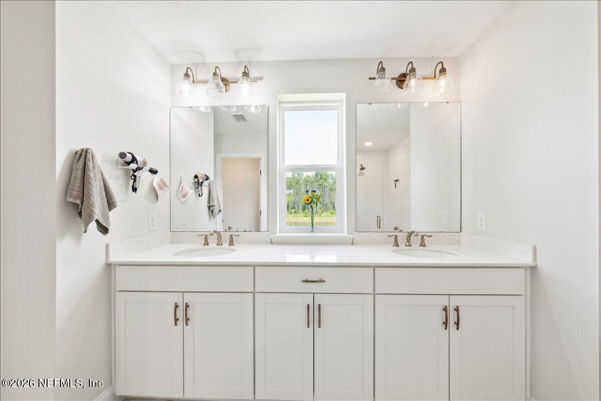 223 Tanner Trail St. Augustine, FL 32092 - Photo 26 of 44 a bathroom with a double vanity sink mirror and