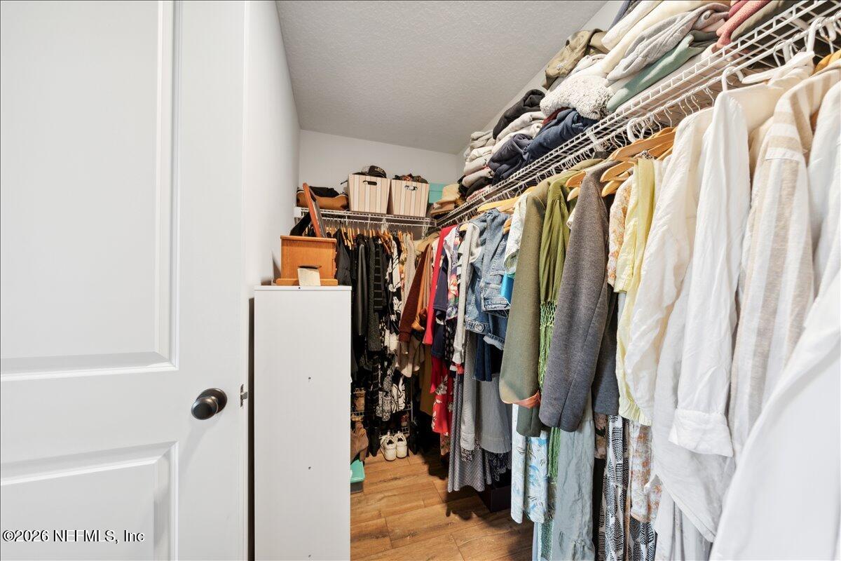 223 Tanner Trail St. Augustine, FL 32092 - Photo 28 of 44 a view of walk in closet with clothes and shoes