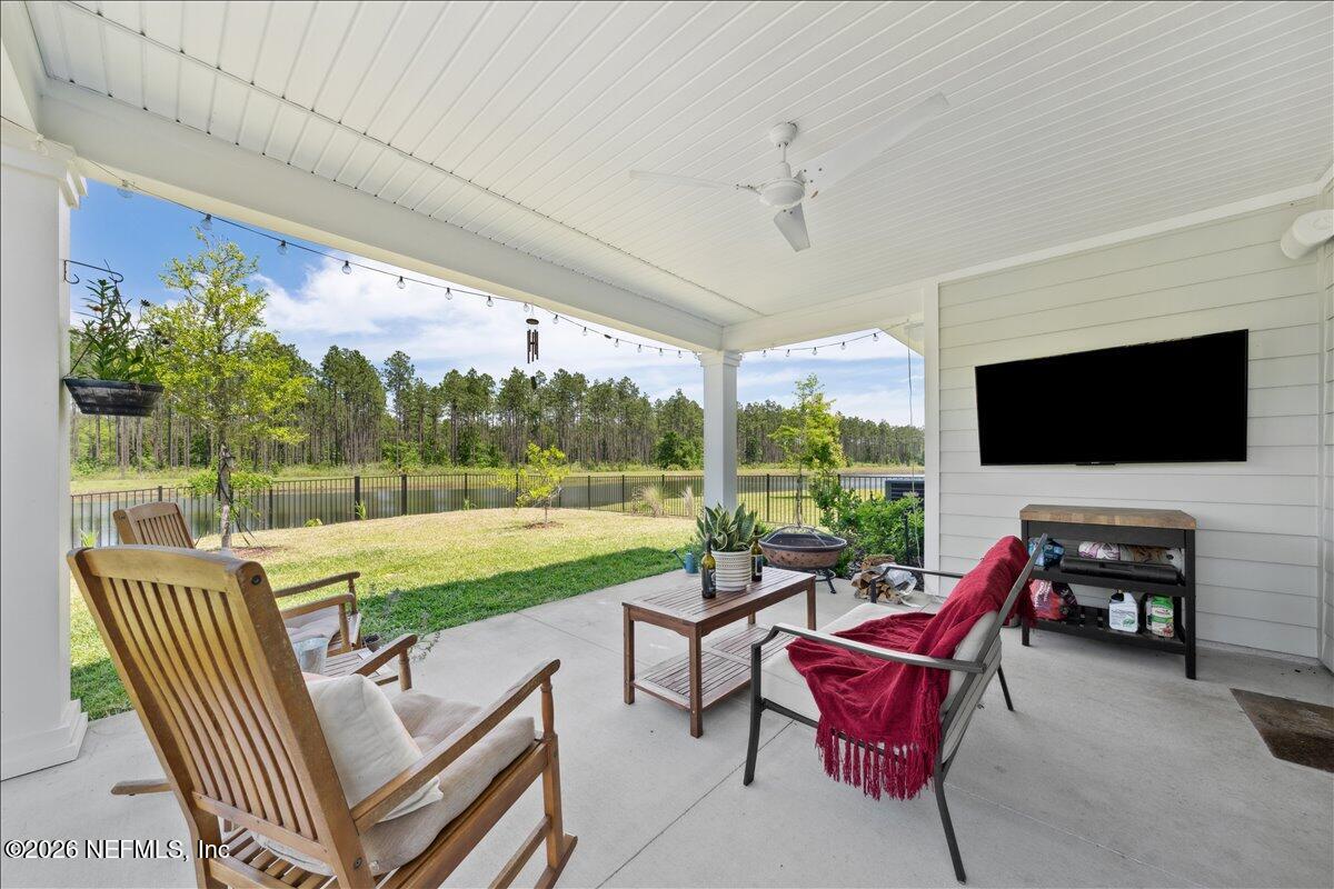 223 Tanner Trail St. Augustine, FL 32092 - Photo 34 of 44 a living room with patio furniture and a flat screen tv
