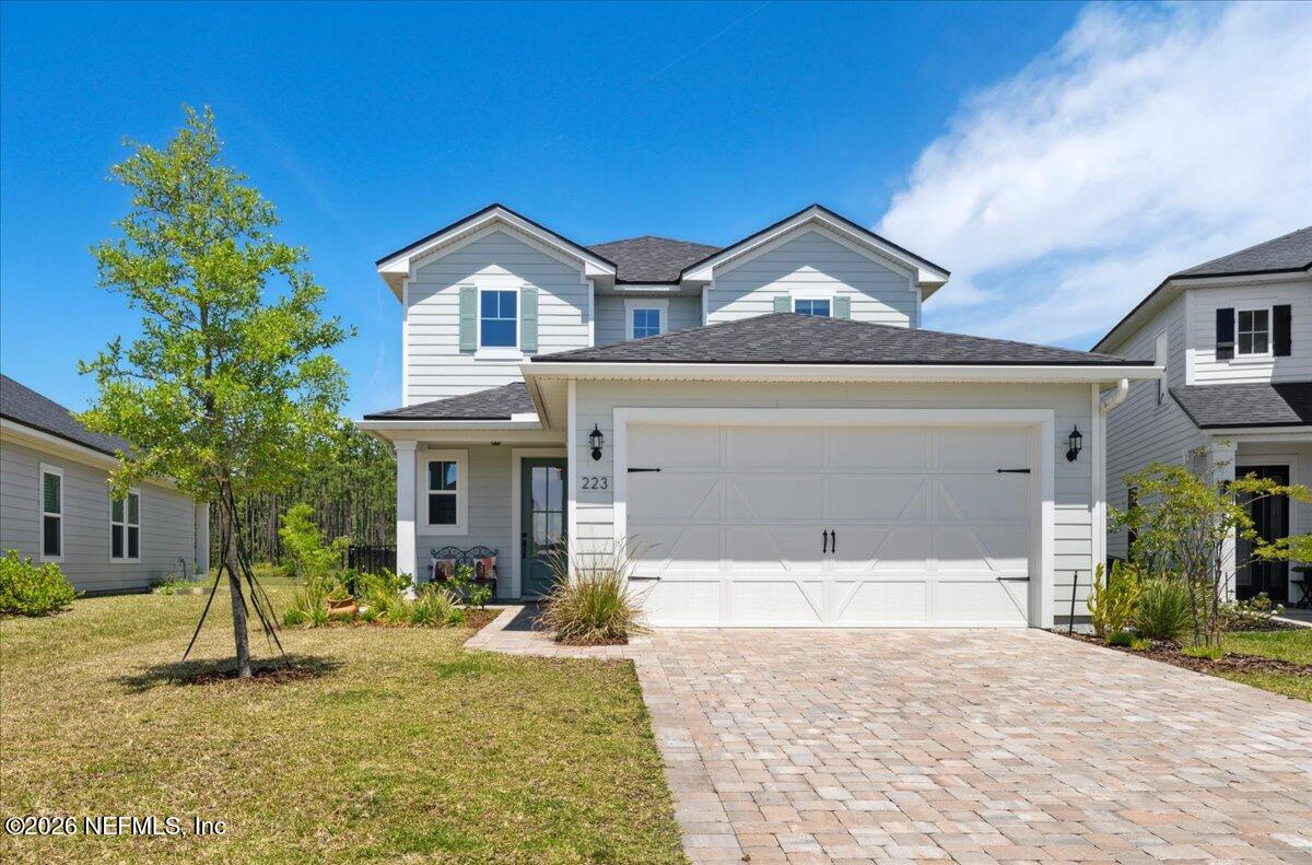 223 Tanner Trail St. Augustine, FL 32092 - Photo 6 of 44 a front view of a house with a yard and garage