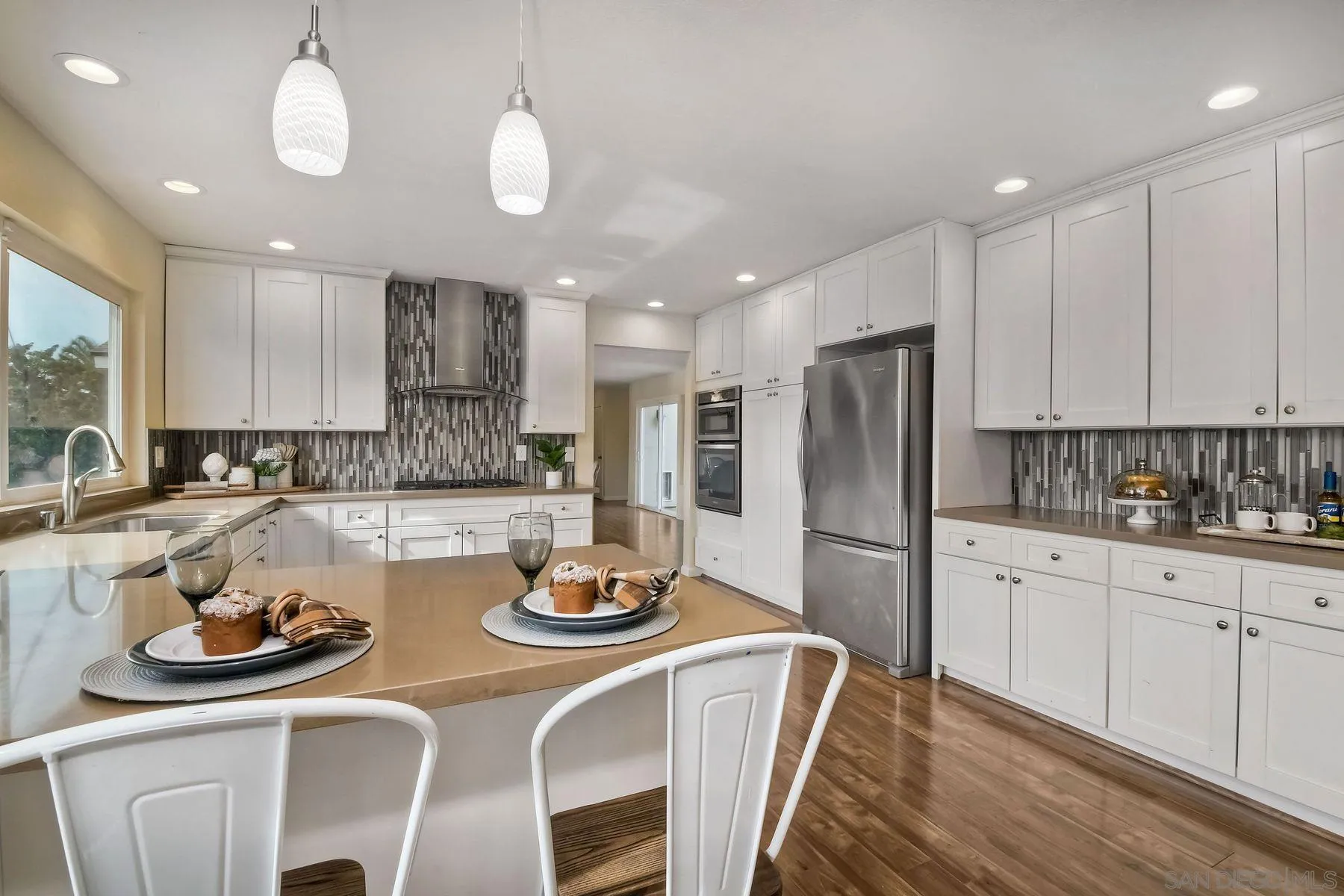 2705 Alexander Drive Escondido, CA 92029 - Photo 12 of 60 a kitchen with a refrigerator a stove a sink and cabinets