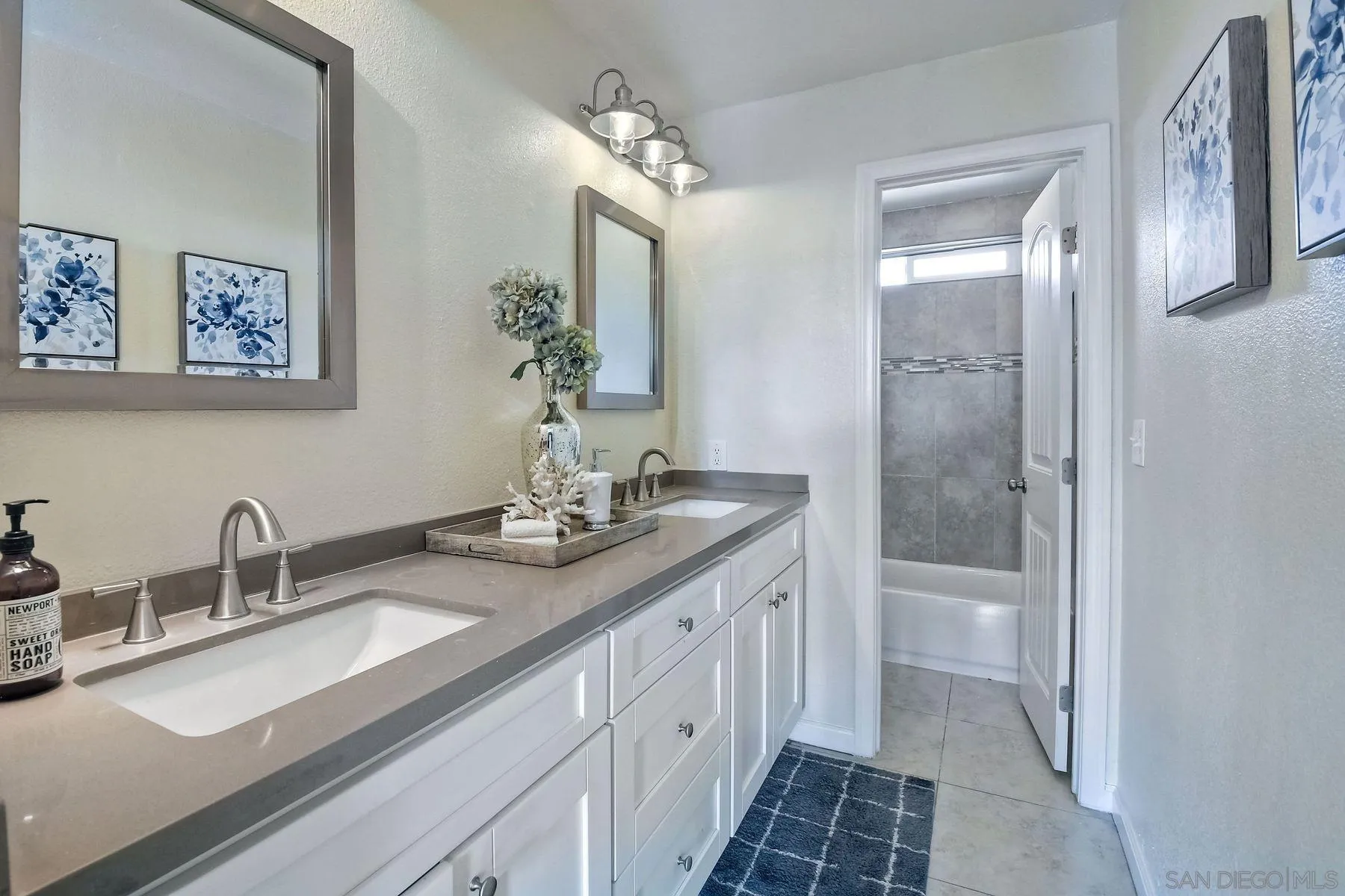 2705 Alexander Drive Escondido, CA 92029 - Photo 16 of 60 a bathroom with a double vanity sink and a mirror