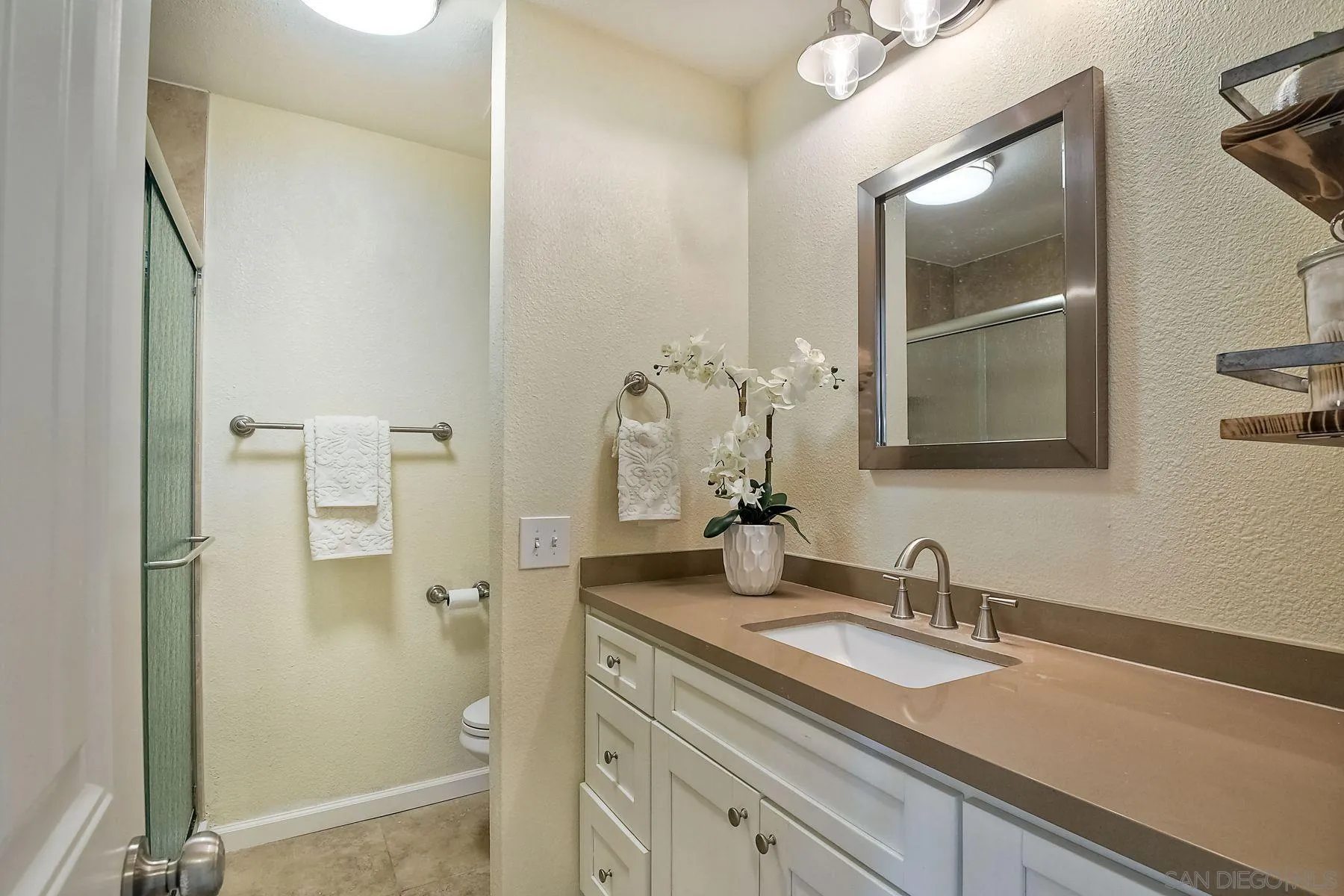2705 Alexander Drive Escondido, CA 92029 - Photo 19 of 60 a bathroom with a granite countertop sink and a mirror