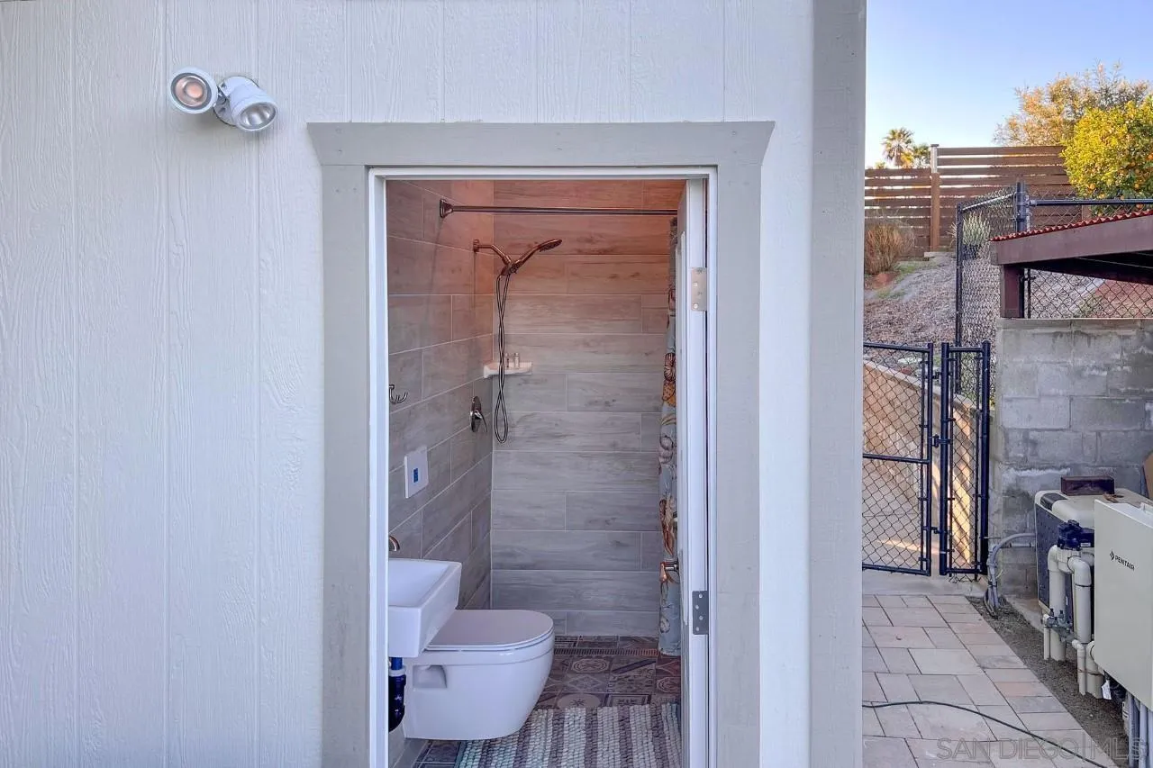 2705 Alexander Drive Escondido, CA 92029 - Photo 31 of 60 a bathroom with a granite countertop sink a toilet and shower