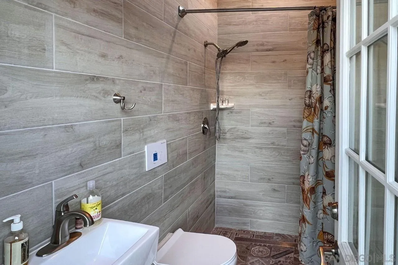 2705 Alexander Drive Escondido, CA 92029 - Photo 33 of 60 a bathroom with a sink toilet and shower