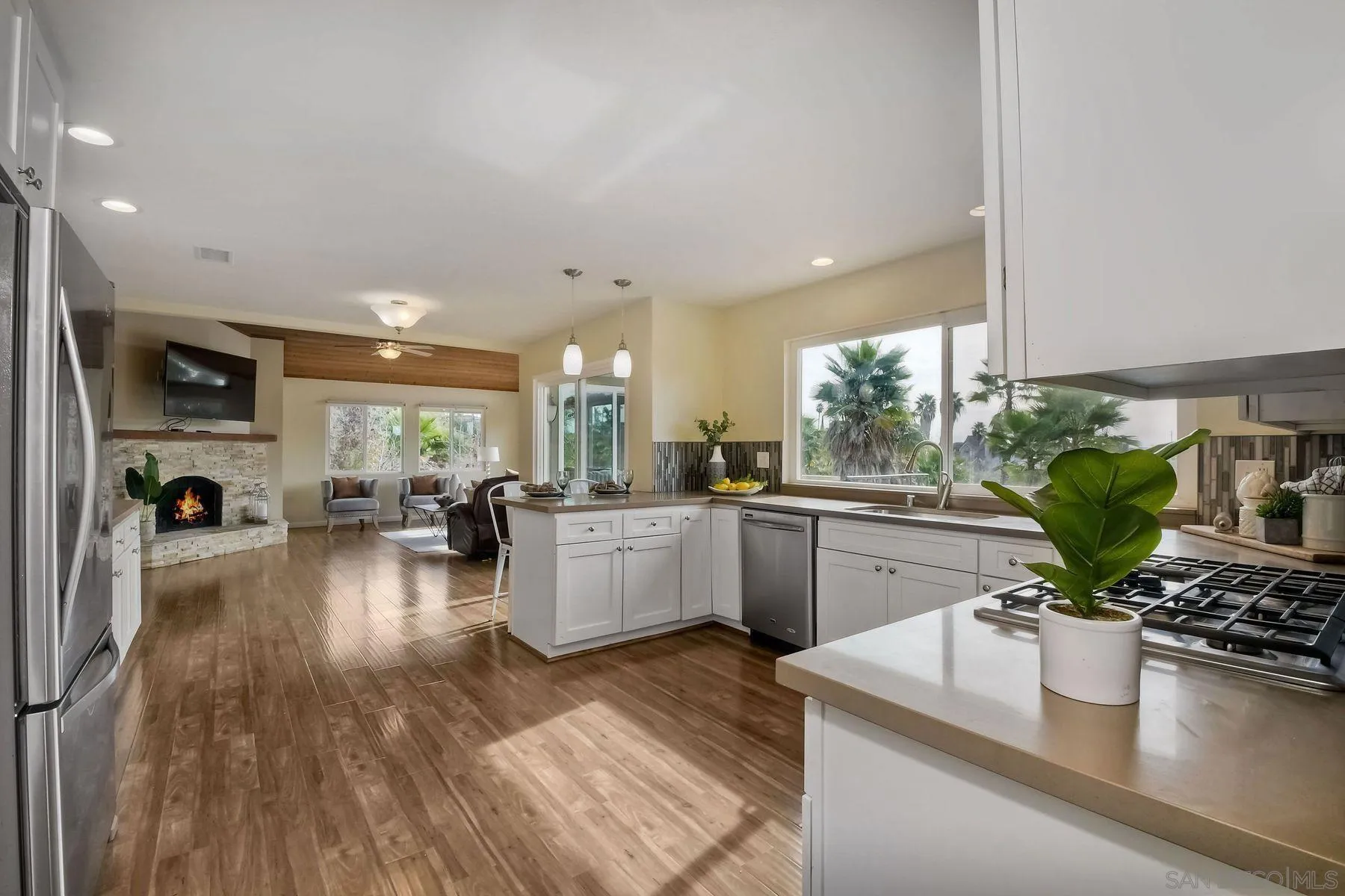 2705 Alexander Drive Escondido, CA 92029 - Photo 9 of 60 a kitchen with sink refrigerator dining table and chairs