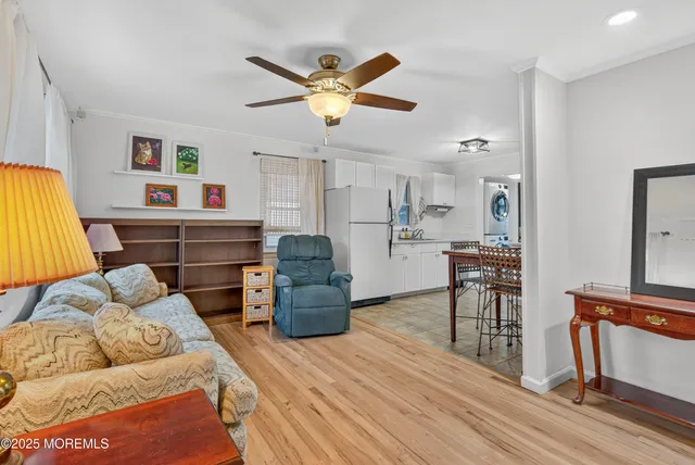 a living room with furniture and kitchen view