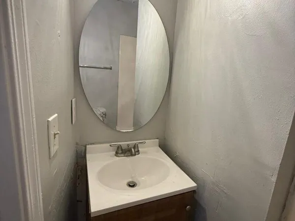 a bathroom with a sink and mirror