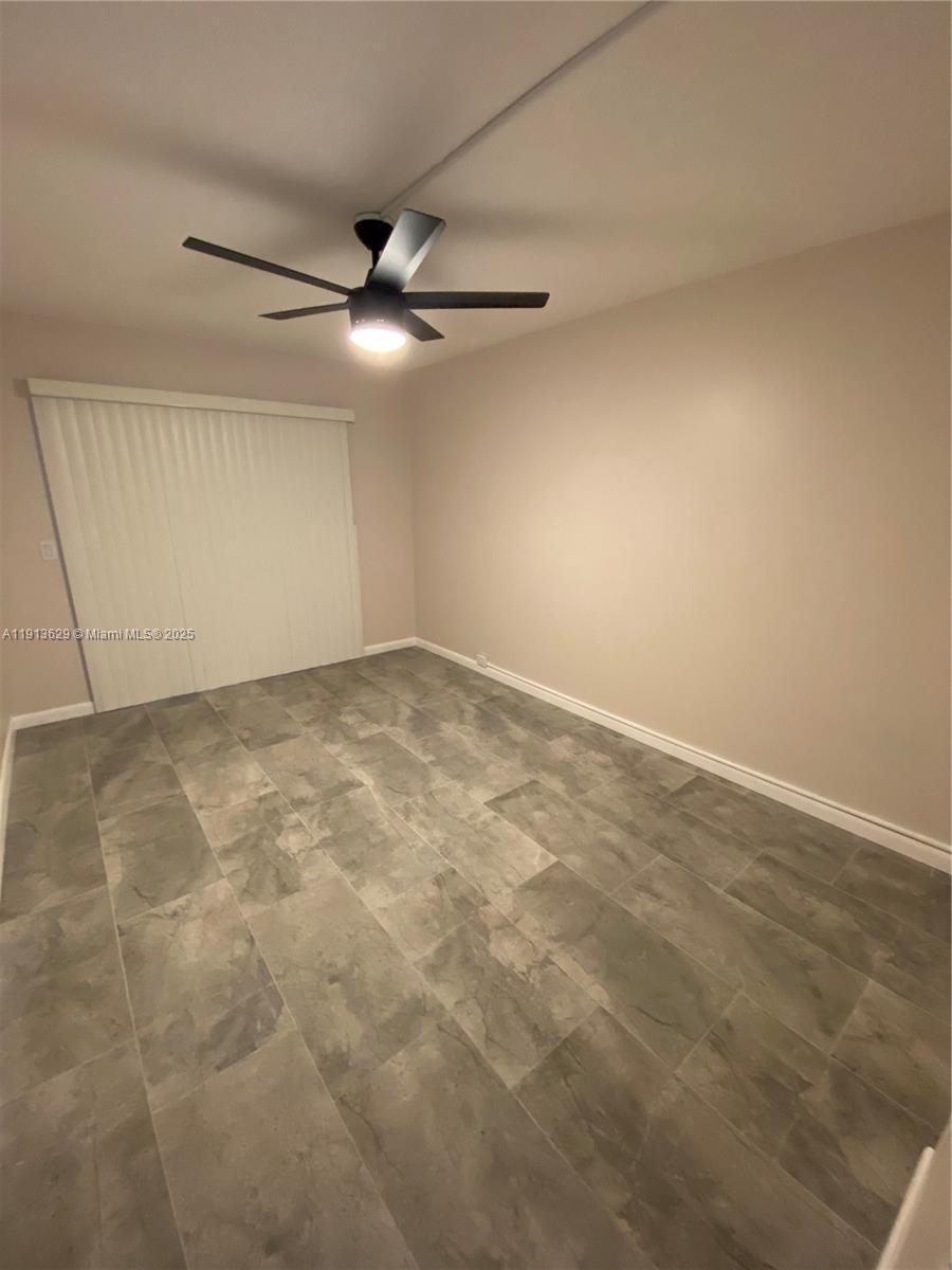 2022 Newcastle B, Unit 2022 Boca Raton, FL 33434 - Photo 13 of 21 an empty room with a ceiling fan and a window