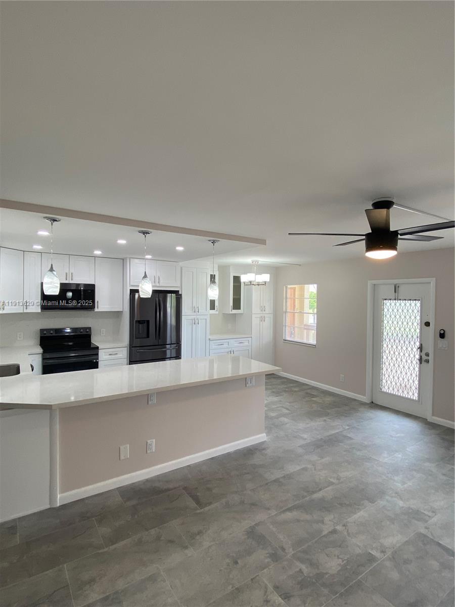 2022 Newcastle B, Unit 2022 Boca Raton, FL 33434 - Photo 3 of 21 a view of a kitchen with large window