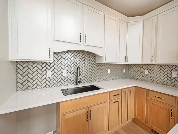a kitchen with a sink and cabinets