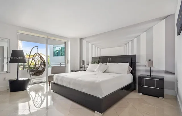 a living room with furniture a chandelier and a large window