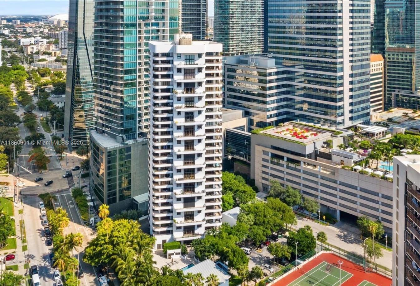 151 Southeast 15th Road, Unit 203/201 Miami, FL 33129 - Photo 2 of 28 a front view of a building with a yard